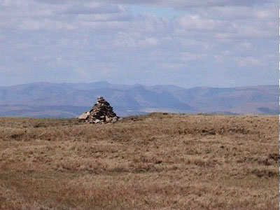 Over towards a cairn with the Lakeland hills in the background