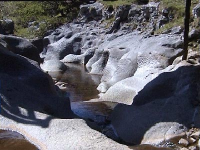 The stragely eroded rocks under the footbridge