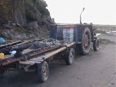 Signs of the seafood industry - A tractor ready with baskets and nets to go out onto the sands