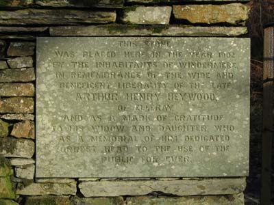 Engraved stone at the side of the gate
